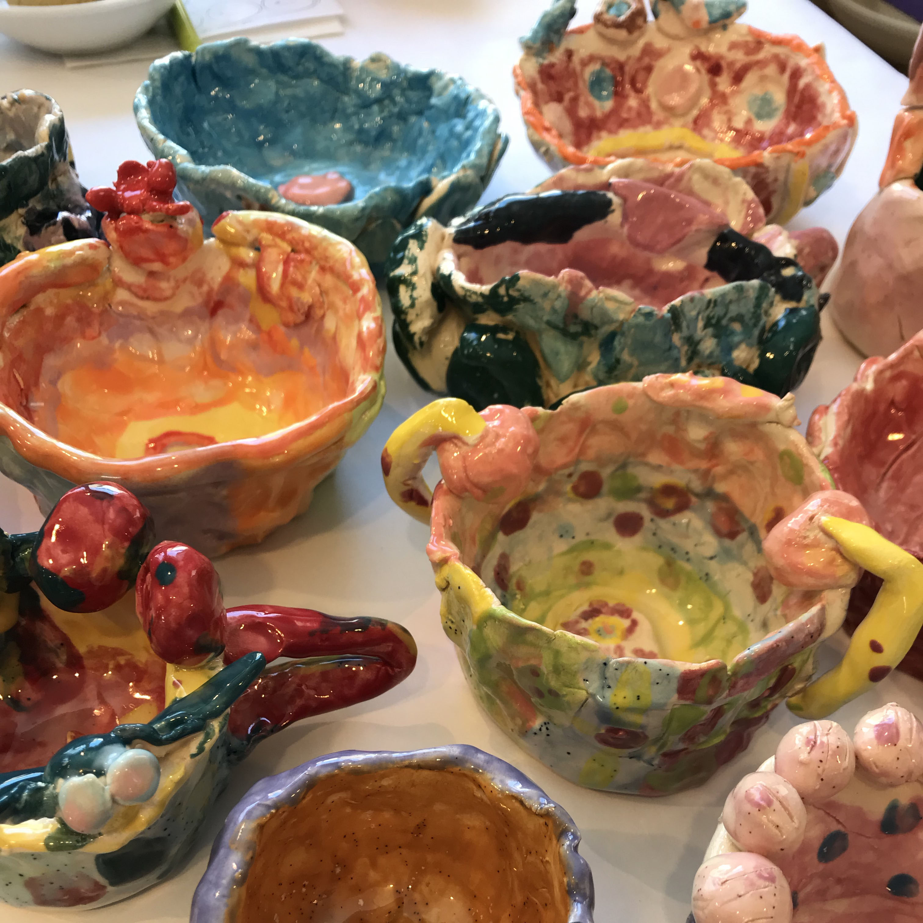 Children's clay pinch pots with colorful glaze