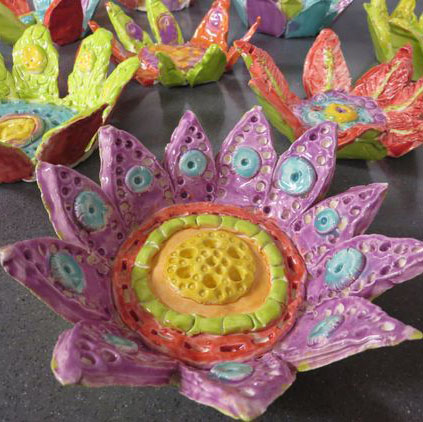 Brightly colored handmade clay flower bowls